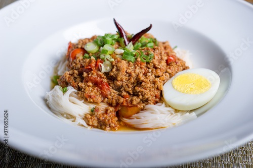 spicy ground pork or beef with tomato and chili on thin asian somen noodle with hard boiled egg 