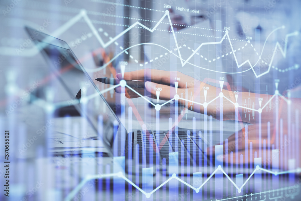 Multi exposure of woman hands typing on computer and financial graph hologram drawing. Stock market analysis concept.