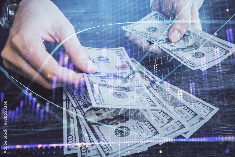 Multi exposure of financial graph drawing hologram and USA dollars bills and man hands. Analysis concept. Multi exposure of financial graph drawing hologram and USA dollars bills and man hands. Analysis concept.