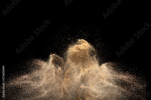 Gold sand explosion isolated on black background. 