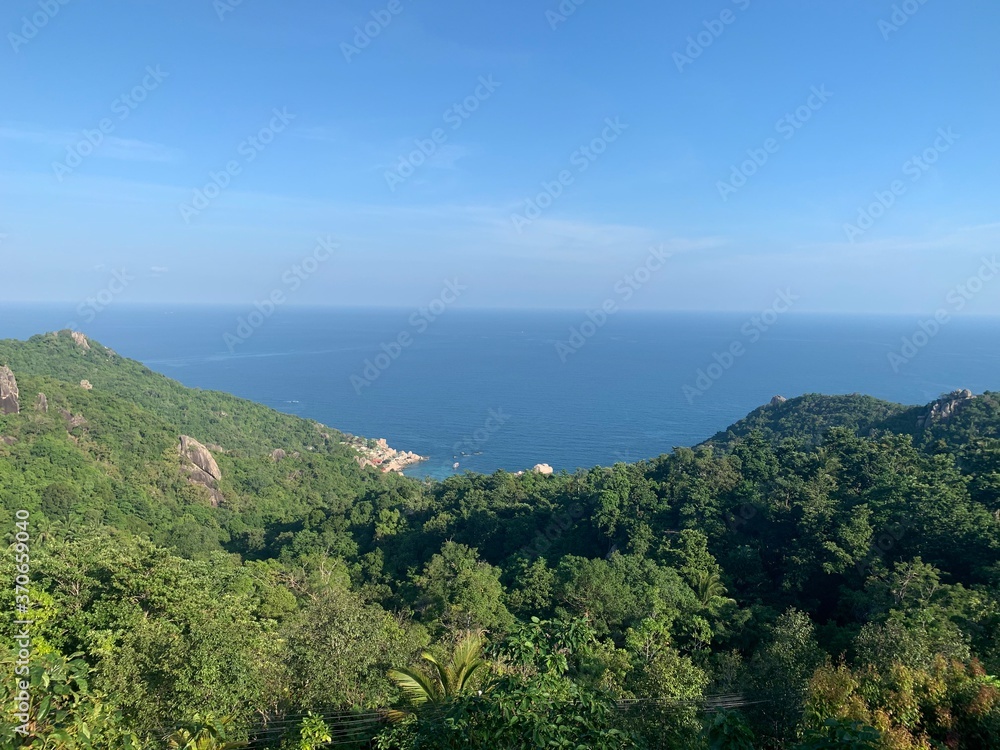 Landscape view of tropical lush mountains overlooking the sea