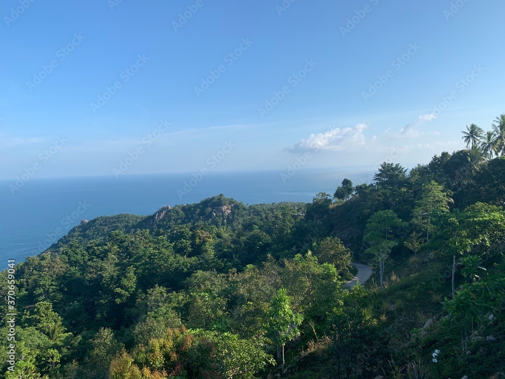 Landscape view of tropical lush mountains overlooking the sea