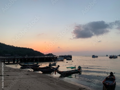 Landscape view of boat beach mountain coastline at sunset 