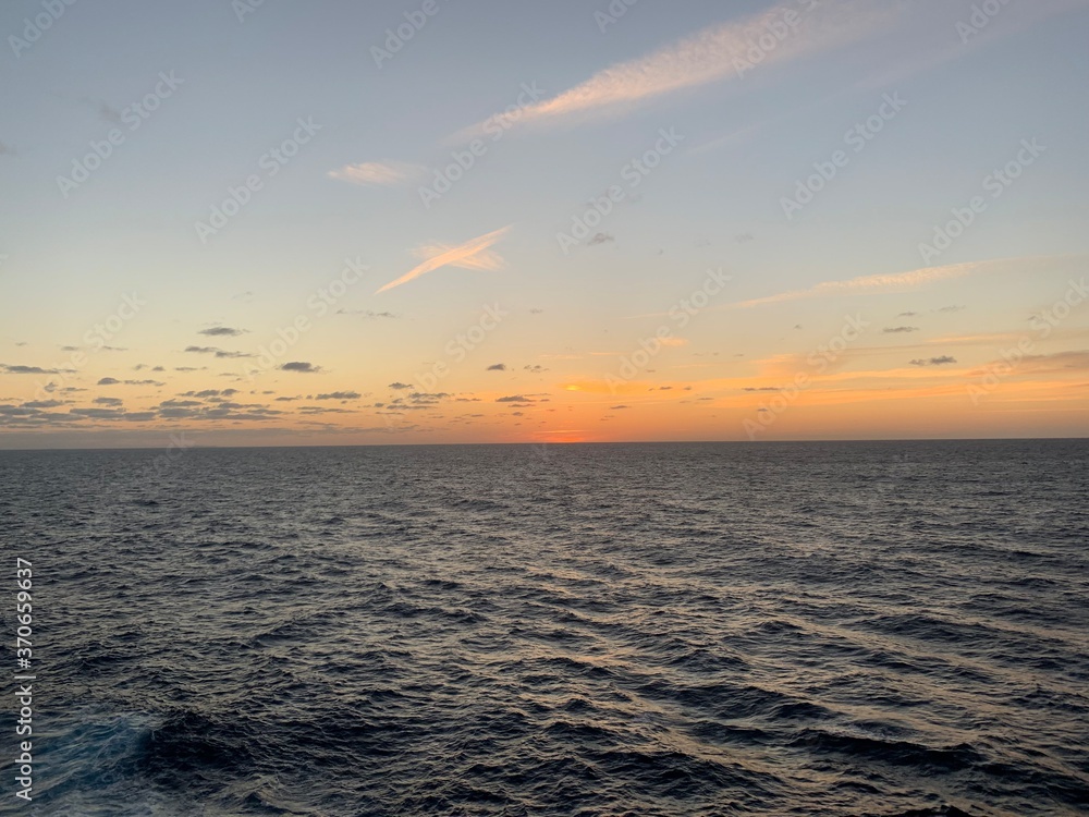 Landscape view of open ocean seascape during vibrant sunset Landscape view of open ocean seascape during vibrant sunset