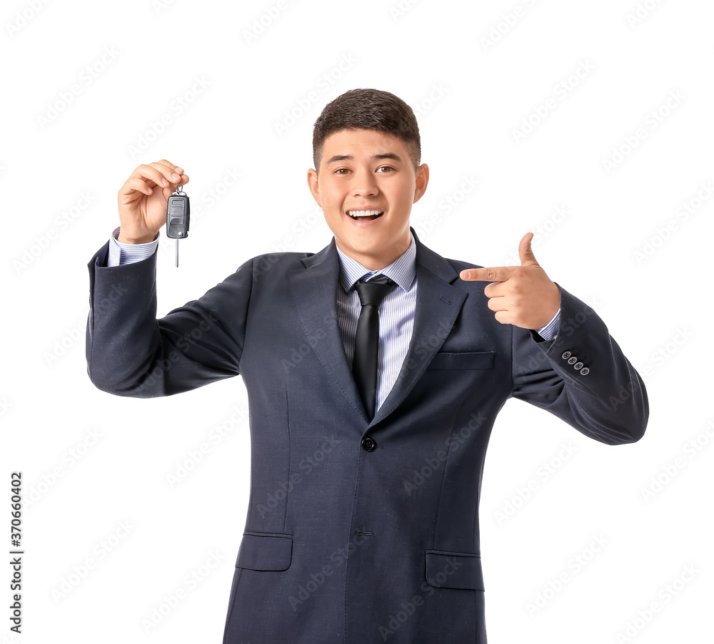 Happy Asian businessman with car key on white background Happy Asian businessman with car key on white background