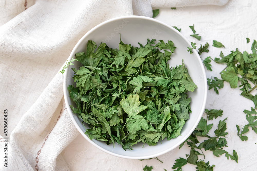 Plate with dry parsley on white background Plate with dry parsley on white background