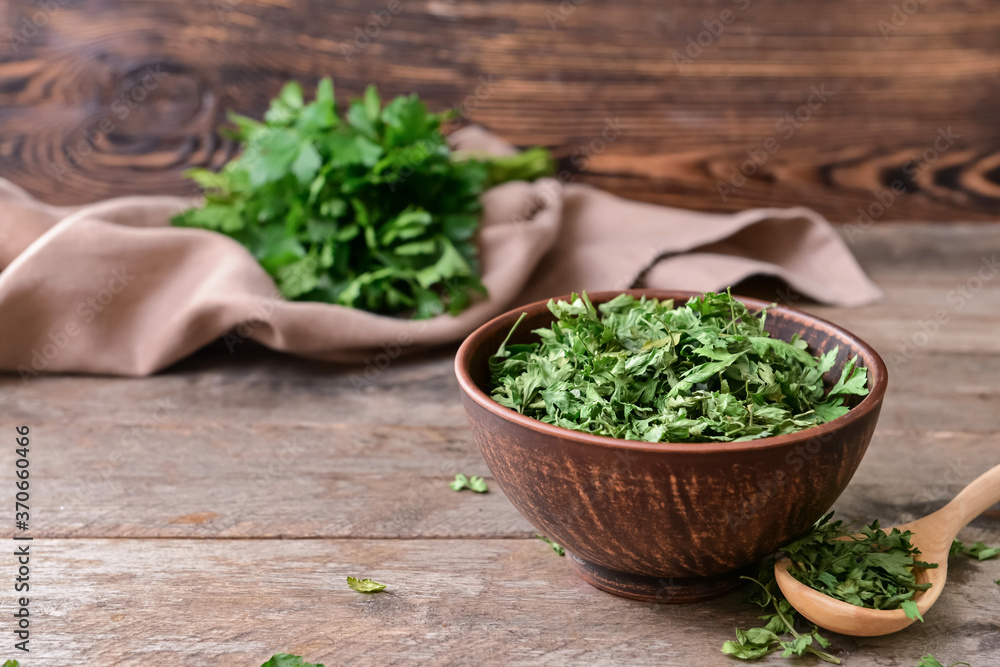 Bowl with dry parsley on table Bowl with dry parsley on table