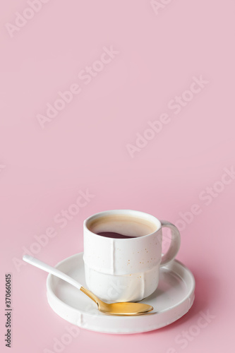 Cup of hot coffee on color background