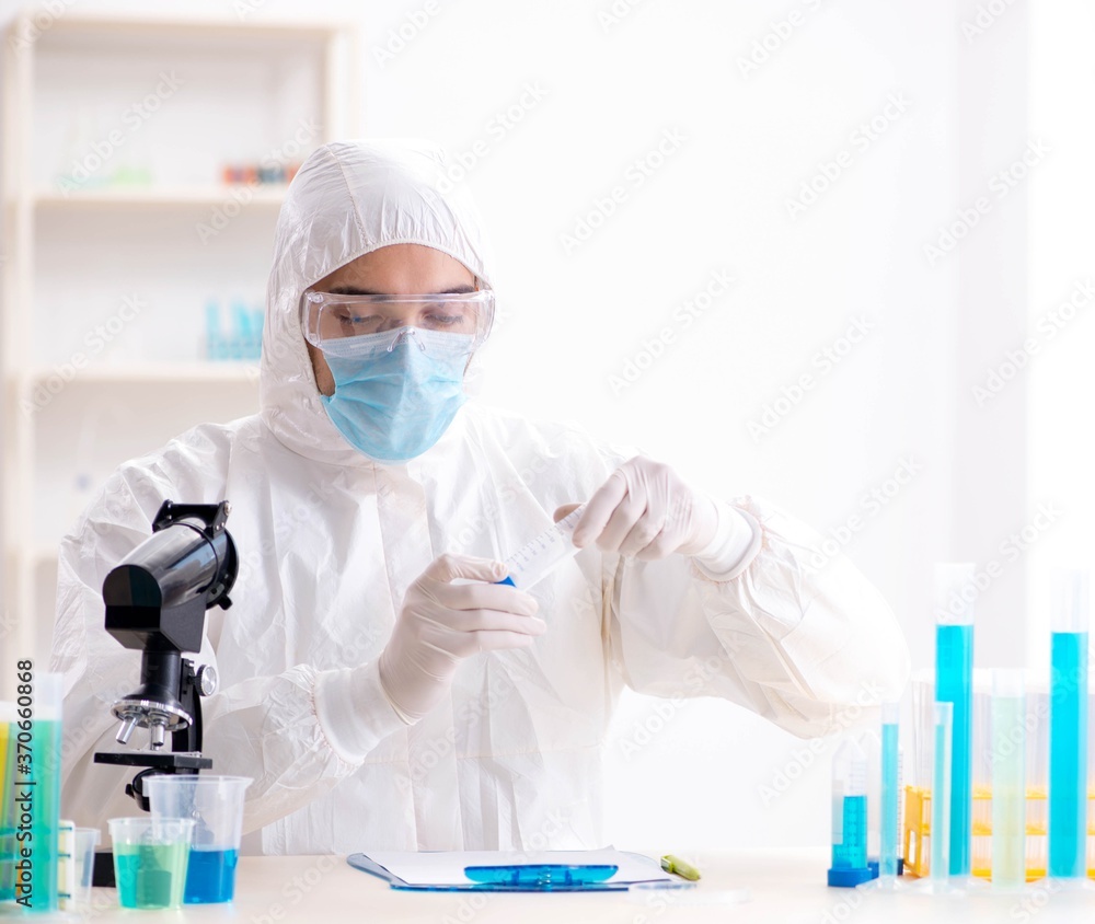 Young chemist student working in lab on chemicals Young chemist student working in lab on chemicals