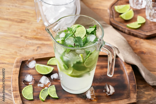 Jug of fresh mojito on table