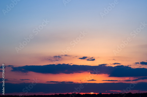 Sunset sky with orange and blue tones in horizon