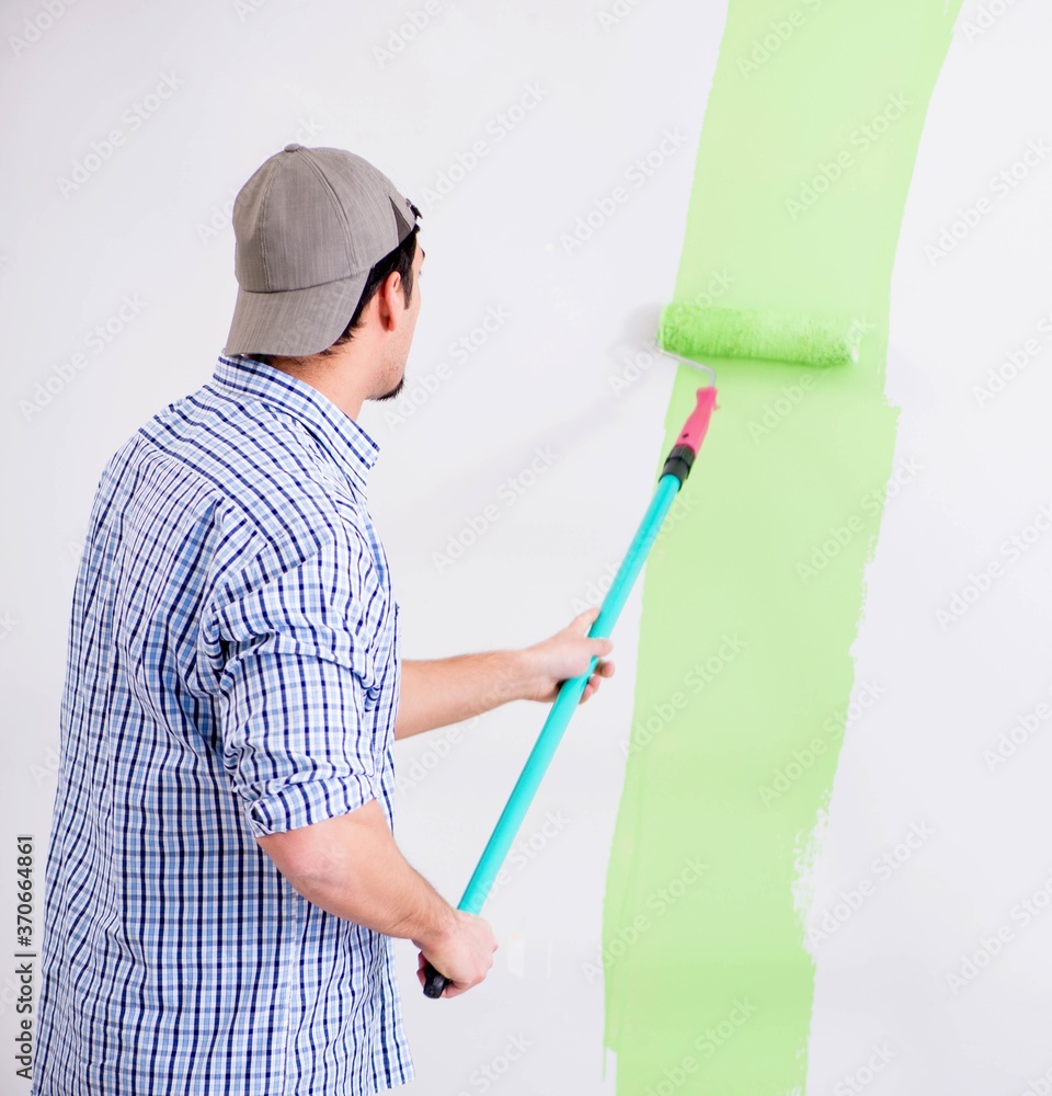 Young painter doing renovation at home Young painter doing renovation at home