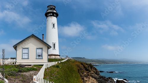 Pigeon Point Lighthouse Tourism and Historic Landmark Building by the Cliff Shoreline, Landscape. Bright Blue Summer Sky, Big Sur, California