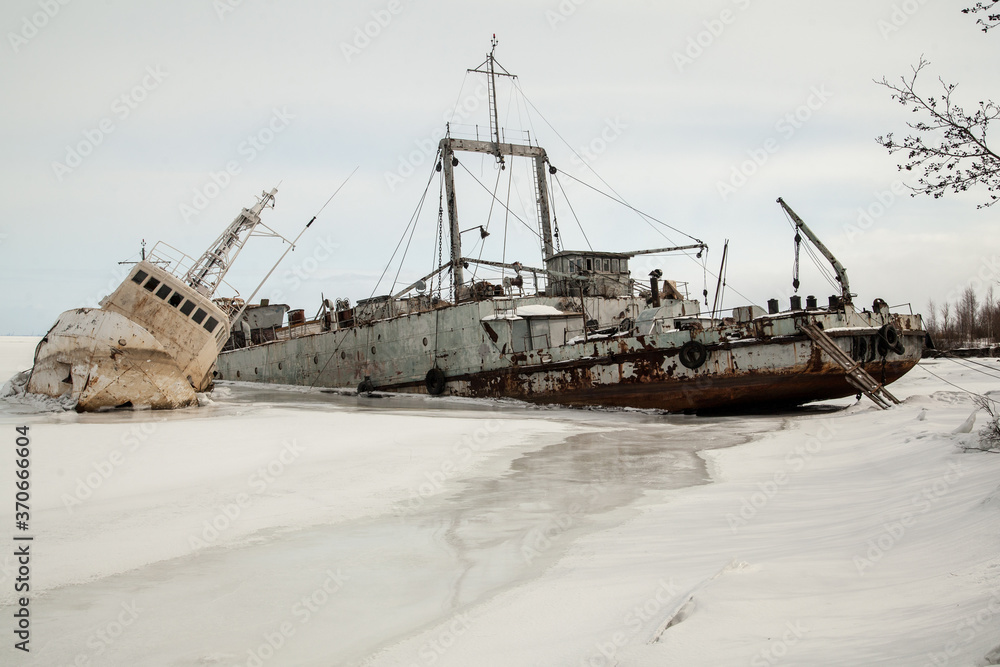 Frozen ship graveyard with two rusty industrial ships Frozen ship graveyard with two rusty industrial ships