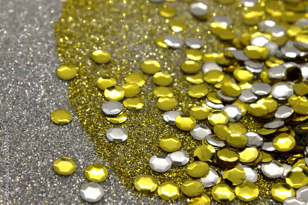 Silver and Gold sequins on a glittery background Silver and Gold sequins on a glittery background