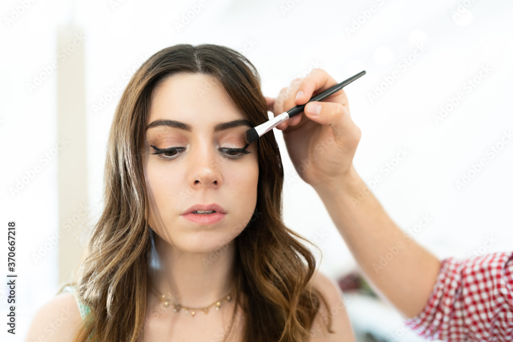 MUA Applying Makeup On Pretty Caucasian Woman