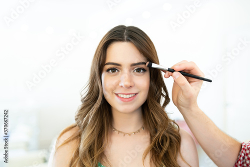 Artist Applying Cosmetic On Pretty Female Customer