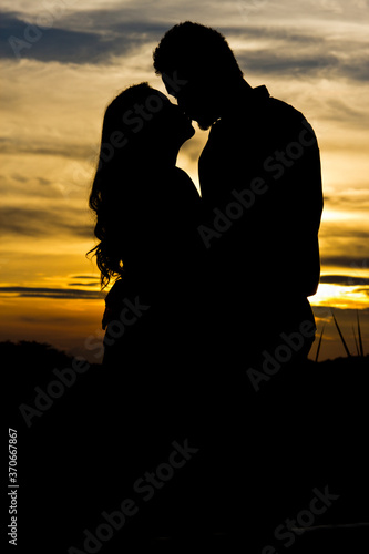 silhouette of a couple kissing