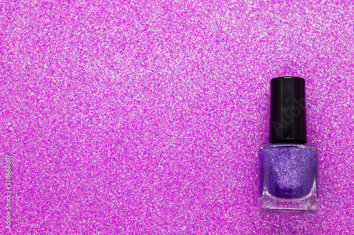 Purple nail polish on a glittery background