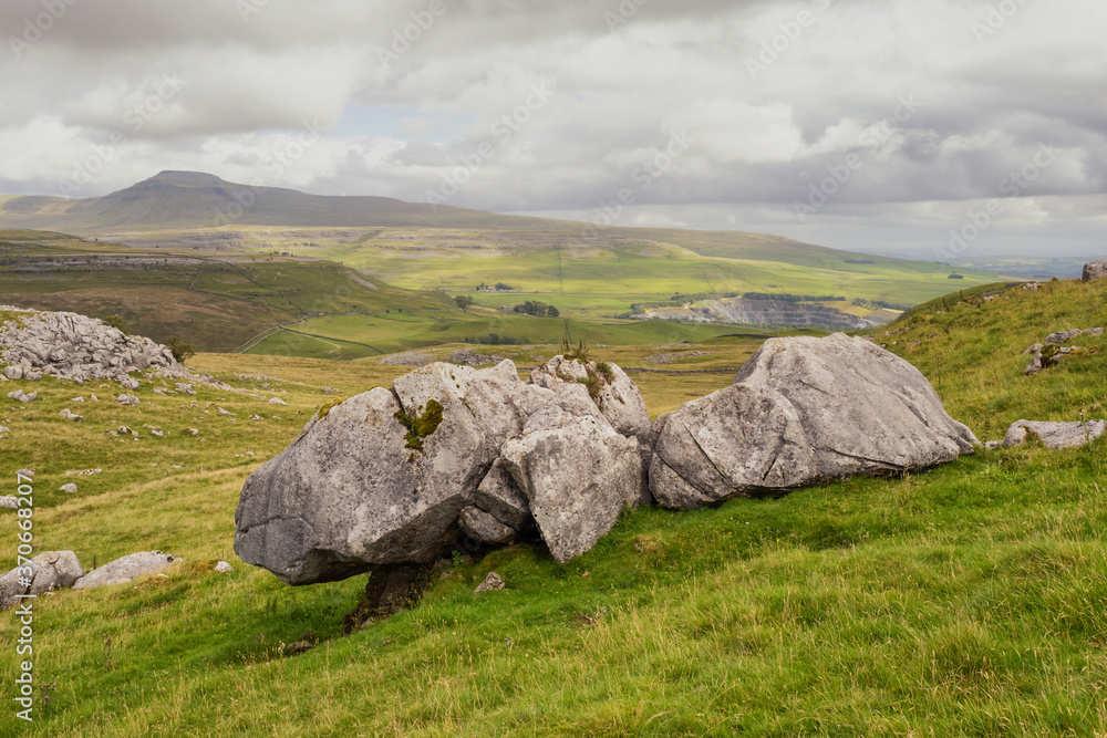 Glacial Erratics on Keld Head Scar with a view to Ingleborough Hill at sunrise, Kingsdale, Yorkshire Dales, North Yorkshire