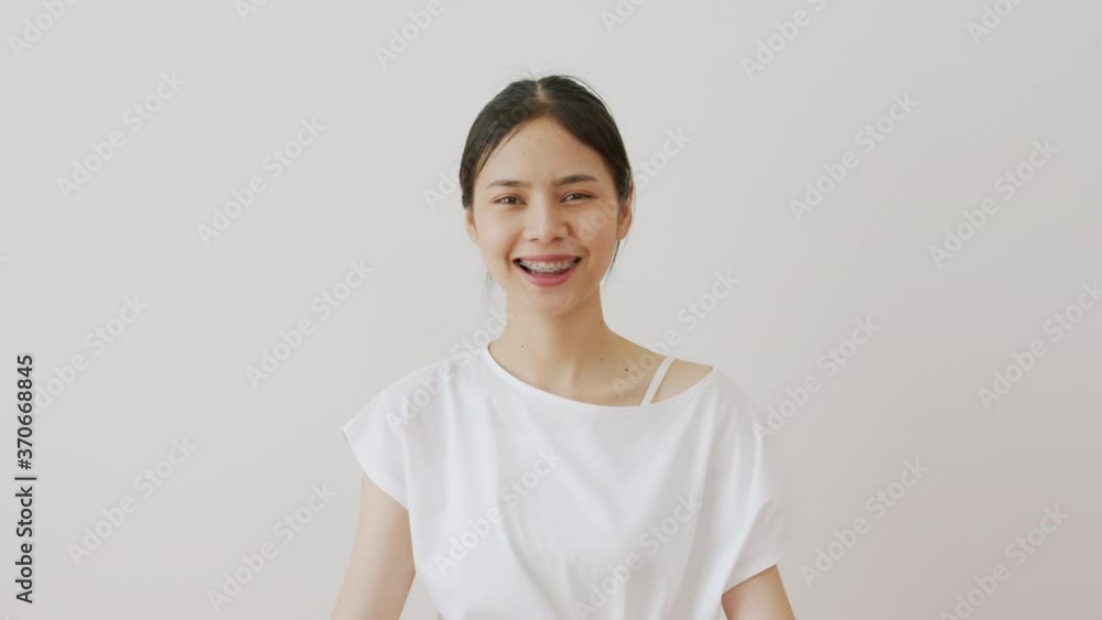 Asian women slowly smiled and laughed happily. A girl wearing braces. Asian women slowly smiled and laughed happily. A girl wearing braces.