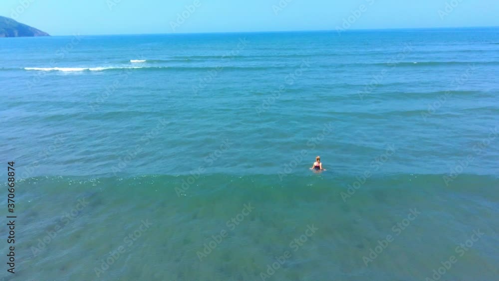 Young girl jumping through waves. Young girl jumping through waves.