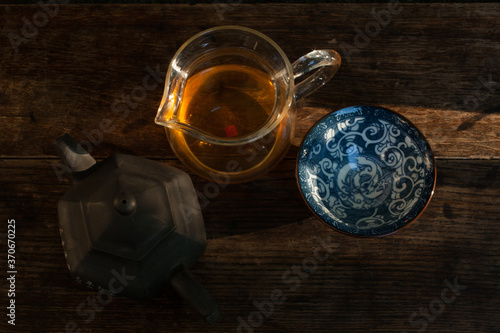 Traditional tea ceremony accessories, teapot and teacup in the sunlight photo