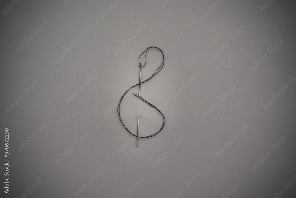 musical note made out of needle and thread. musical note made out of needle and thread.