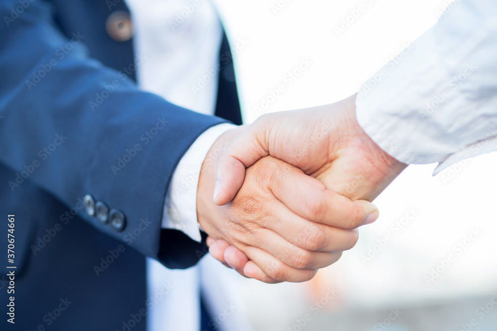 Business people shake hands to agree to a new business Business people shake hands to agree to a new business