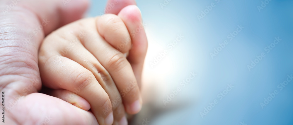 baby's hand in father's hand