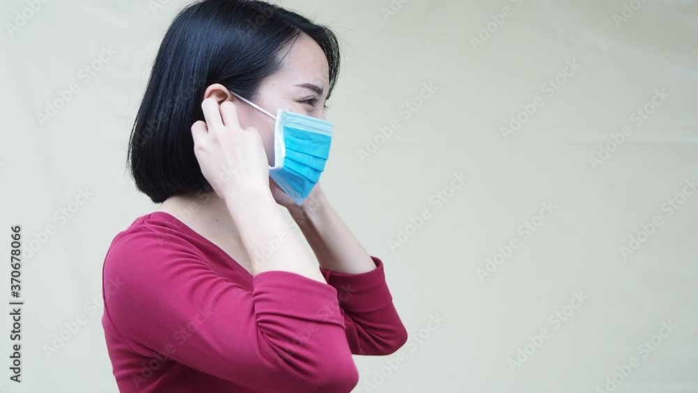 woman demonstrate how to gloves protective mask for corona virus prevention, standing on white background copy-space. waring mask footage. woman demonstrate how to gloves protective mask for corona virus prevention, standing on white background copy-space. waring mask footage.