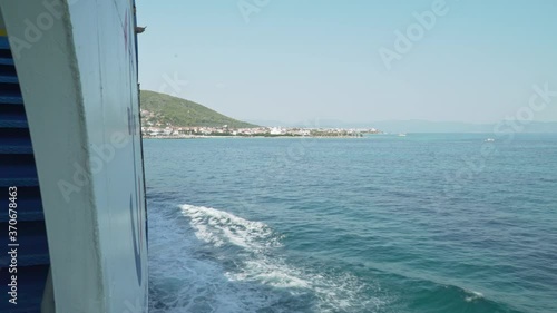 Slow motion footage from ferry boat at sea, approaching the port of Agkistri island, Argosaronikos, Greece photo