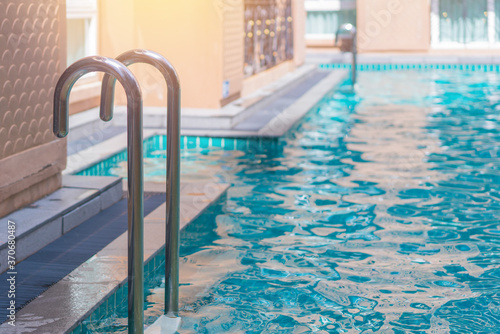 blue swimming pool at hotel with stair