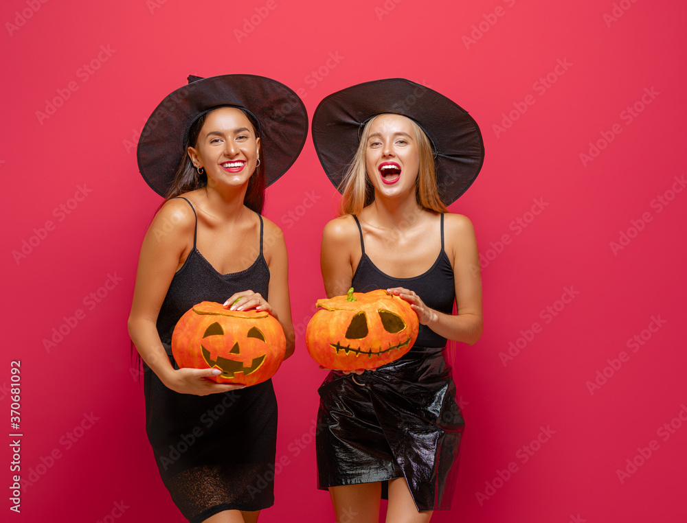 Fototapeta premium Two young women in black witch costumes