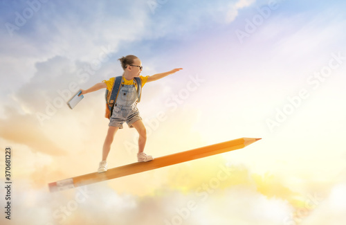 child flying on a pencil