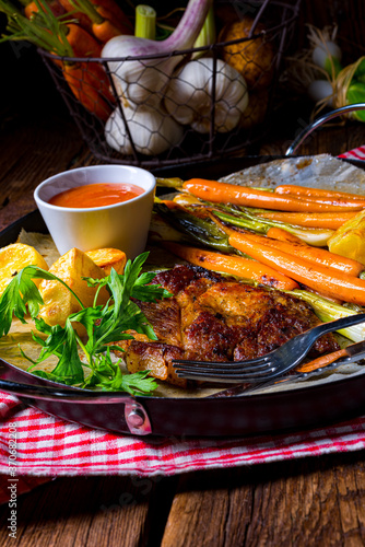 grilled neck chops with caramelized vegetables. photo