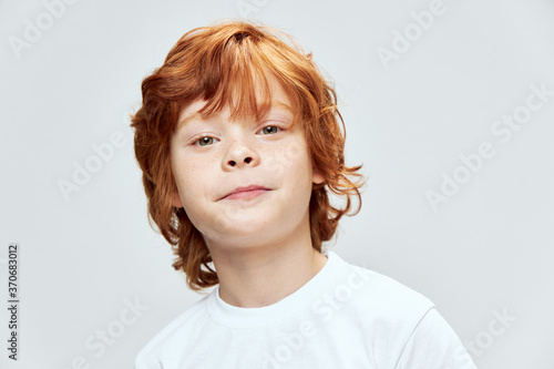 portrait of redhead boy face close up studio cropped view white t-shirt 
