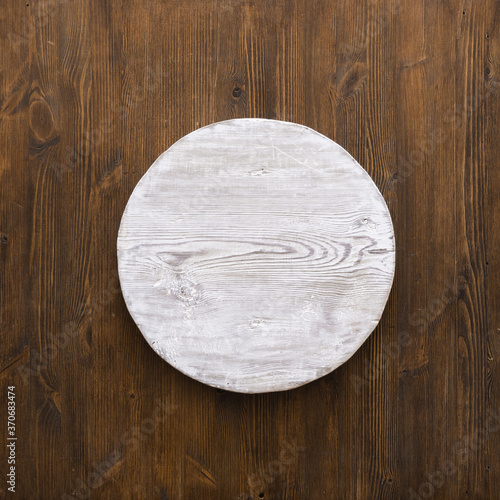 round wooden plate on old wooden background