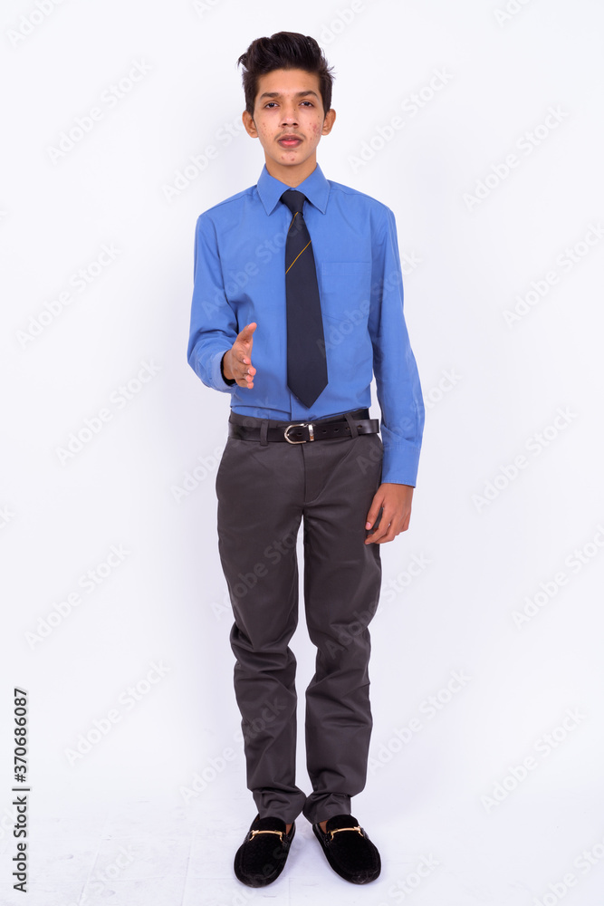 Portrait of young handsome Indian teenage boy as businessman