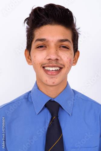 Portrait of young handsome Indian teenage boy as businessman