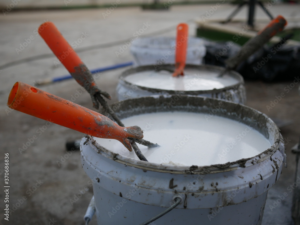 paint roller in the paint bucket for in renovation building. paint roller in the paint bucket for in renovation building.