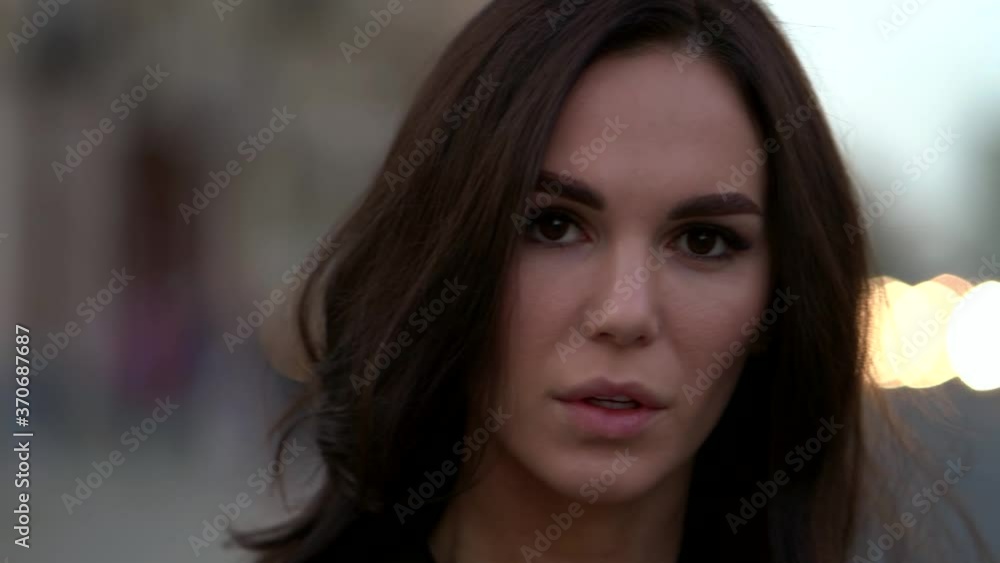 charming natural beauty woman with long dark hair is looking at camera charming natural beauty woman with long dark hair is looking at camera