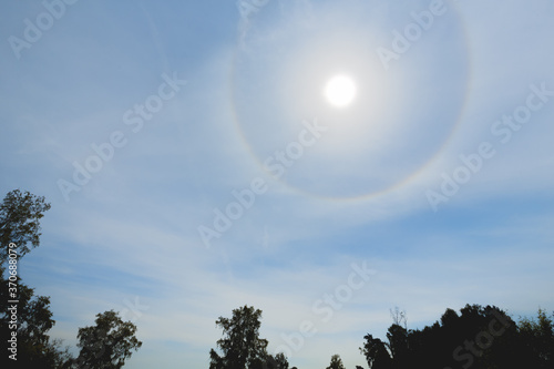 Atmospheric optical effect circle around the sun on hot summer day. Atmospheric halo phenomenon around the sun