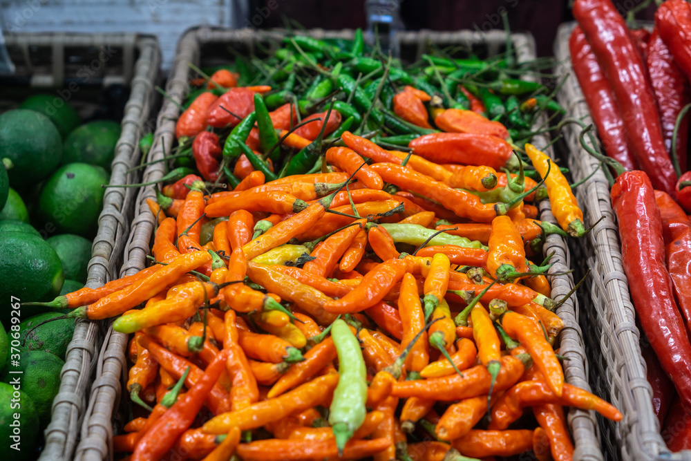Basket with red and green chilli pepper in the shop . Basket with red and green chilli pepper in the shop .