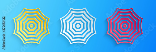 Paper cut Sun protective umbrella fo beach icon isolated on blue background. Large parasol for outdoor space. Summer vacation or picnic accessory. Paper art style. Vector.