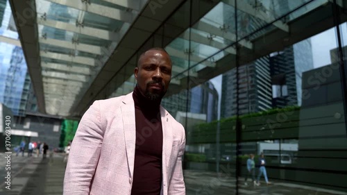 Wallpaper Mural serious successful afro-american man is walking alone in big modern city, black male city dweller Torontodigital.ca