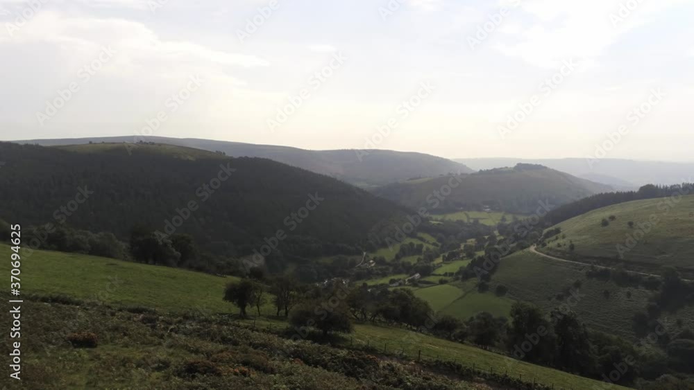Aerial view Horseshoe pass lush scenic misty mountain valley picturesque rural countryside rising establishing shot Aerial view Horseshoe pass lush scenic misty mountain valley picturesque rural countryside rising establishing shot