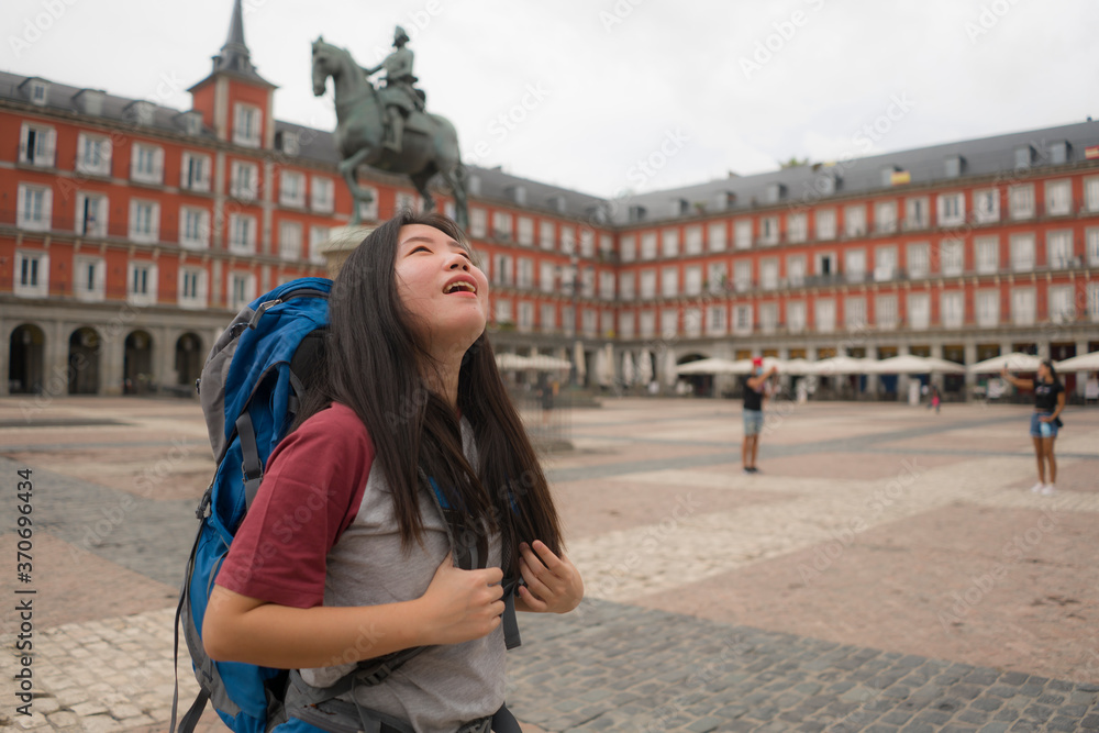 young Asian woman visiting Europe in holidays as backpacker tourist - happy and attractive Korean girl enjoying city tour cheerful in tourism and vacation travel concept