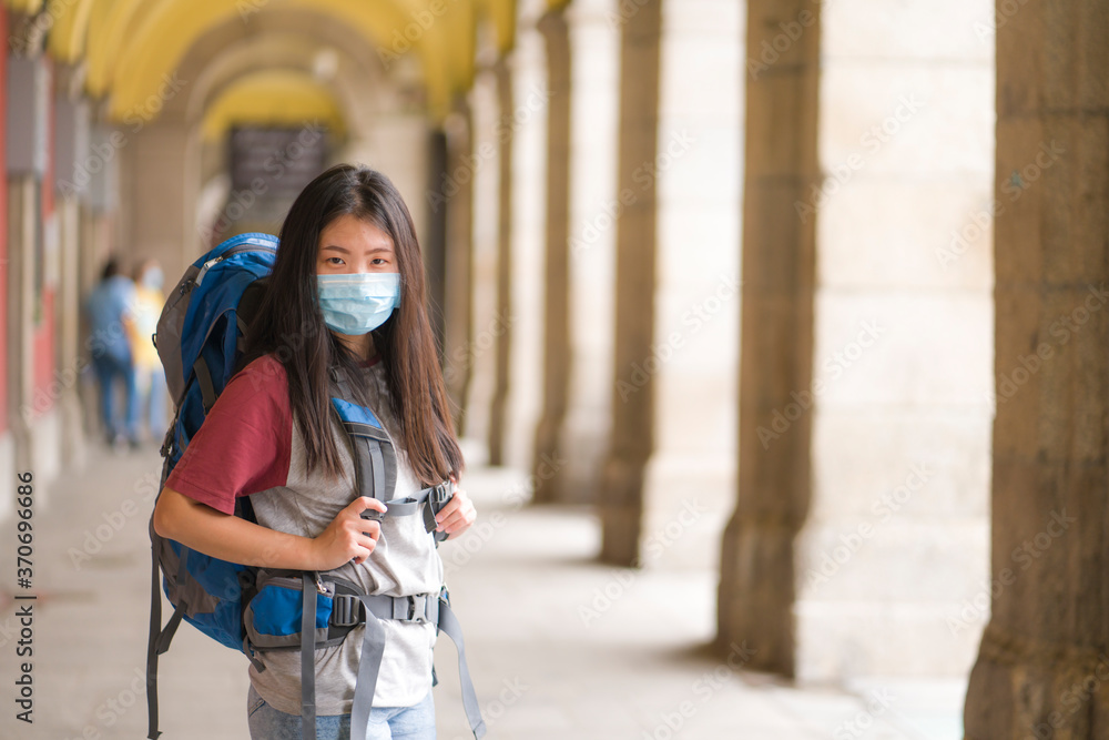 new normal backpacker in holidays travel - young happy and attractive Asian Korean woman in face mask enjoying city tour cheerful in post covid19 lockdown tourism