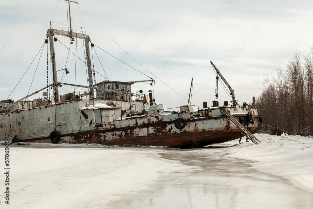 Frozen ship graveyard with two rusty industrial ships